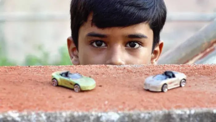 Indian kids playing with cars
