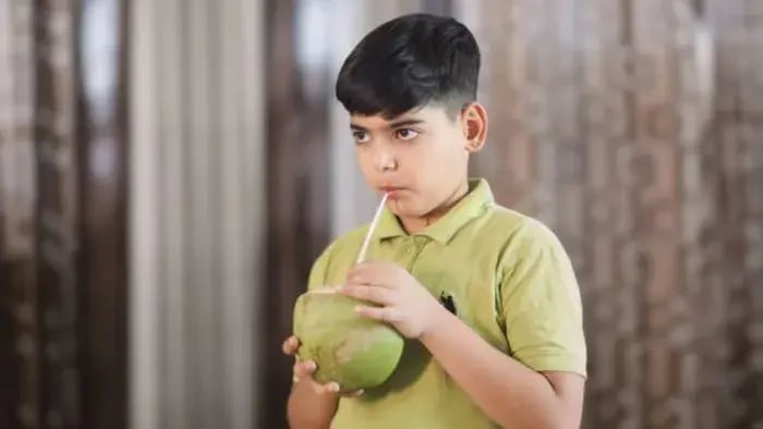 Indian Kid Drinking Coconut Water