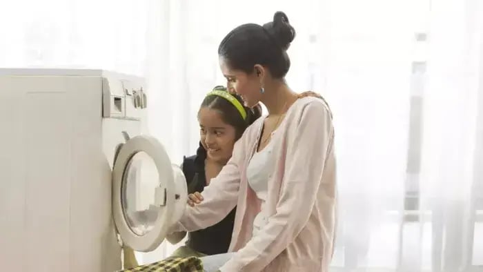 5 Practical Ways Children Can Support Their Parents at Home - Indian kids washing clothes with parents