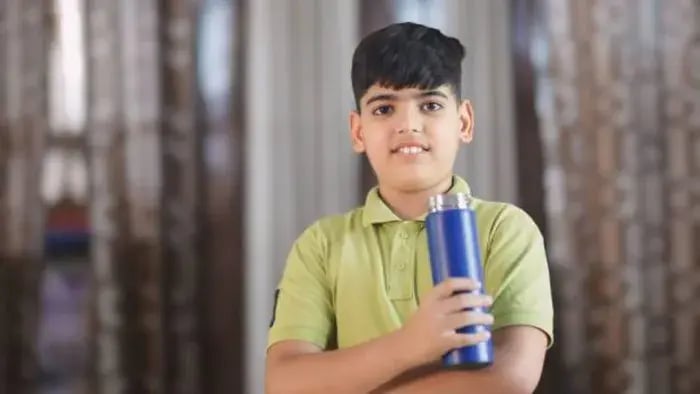 Indian kid drinking water