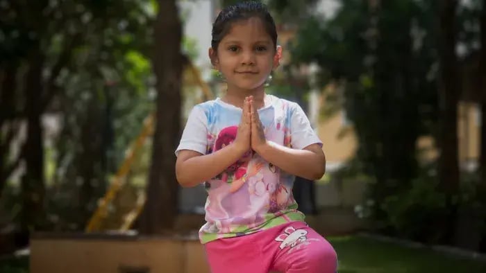 7 Easy Yoga Poses for Kids: Fun and Simple Ways to Stay Fit - kid folding hands while standing on one leg