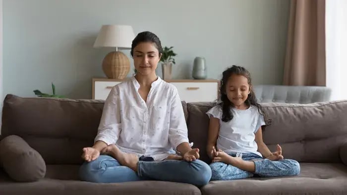 7 Easy Yoga Poses for Kids: Fun and Simple Ways to Stay Fit - Mother and daughter doing yoga on a sofa