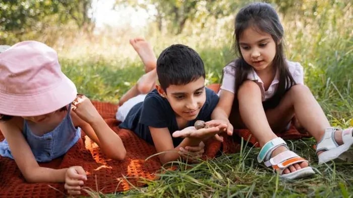7 Effective Ways to Improve Mental Health for Teens and Adults - Three kids laying on grass