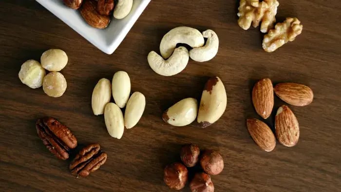 different types of nuts like cashews and peeled almonds