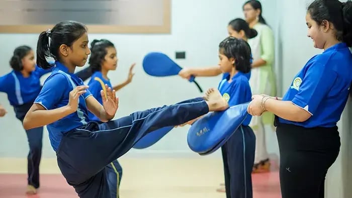 kids playing a game under the assistance of teachers
