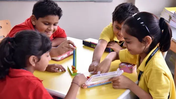 kid sitting in a group-kids doing an activity