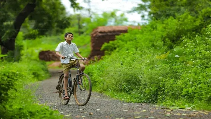 kid cycling on the road