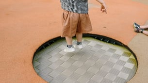 kid jumping on a trampoline