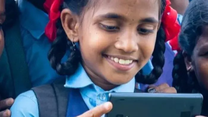 Girl Smiling While Watching Something On Phone.
