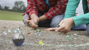 Kids playing with marbles