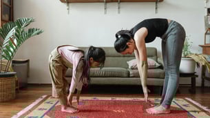 Kid exercising with mother