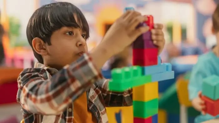 kid playing with blocks