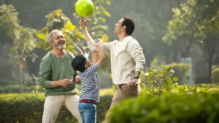 Indian kids playing in park with parents
