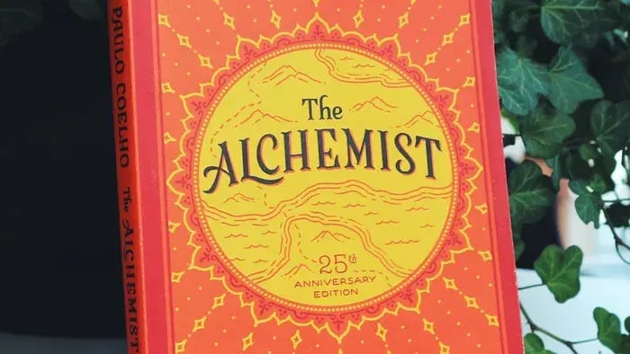 orange and yellow book cover with alchemist written in the centre