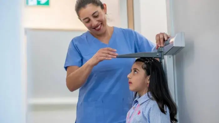 Indian kids and parents measuring height
