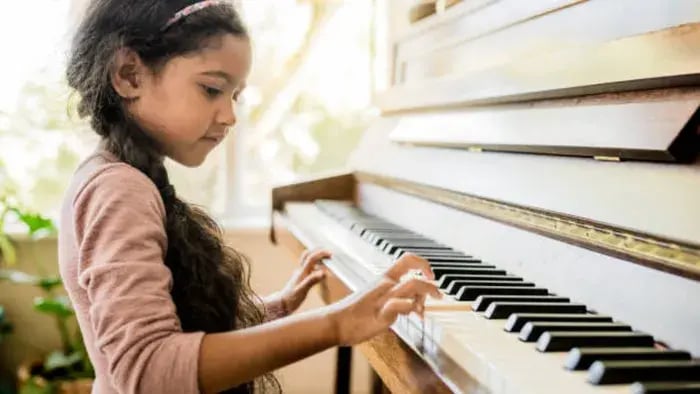Indian kid playing piano