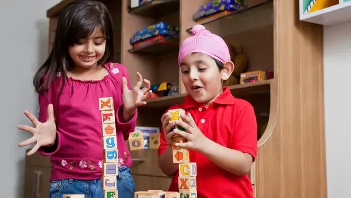 two kids playing with building blocks