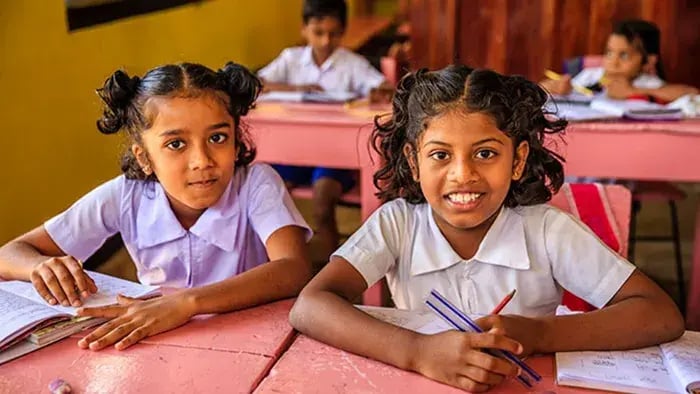 girls smiling-girls sitting in a classroom and smiling