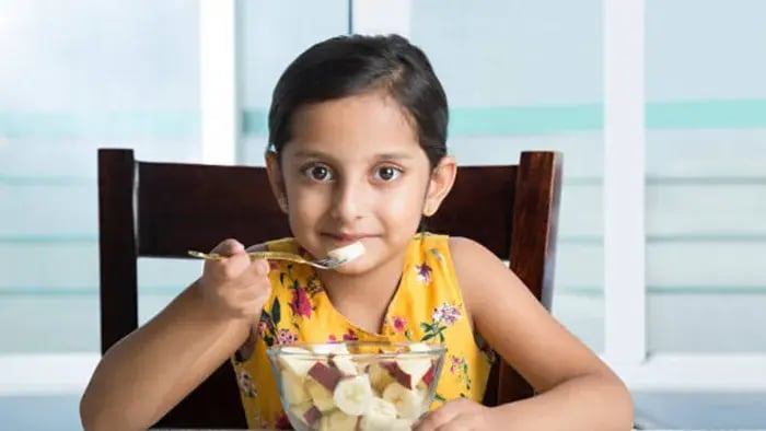 Indian Kid Eating Fruits