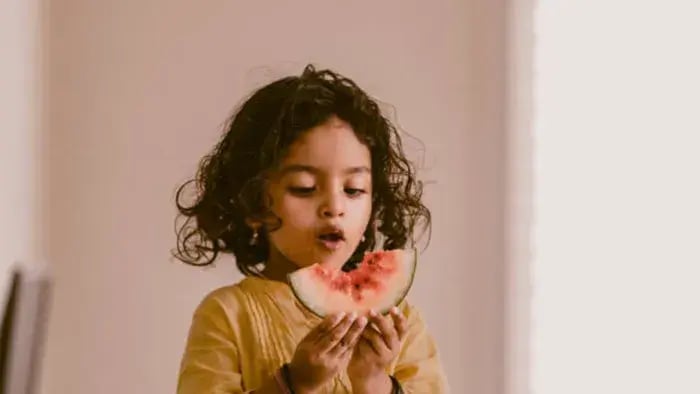 Indian Kid Eating Fruits