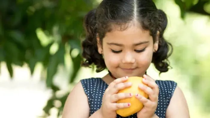 Indian Kid Eating Fruits