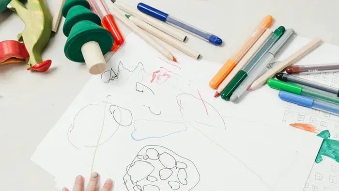 drawing sheet and colors-kid drawing on a sheet
