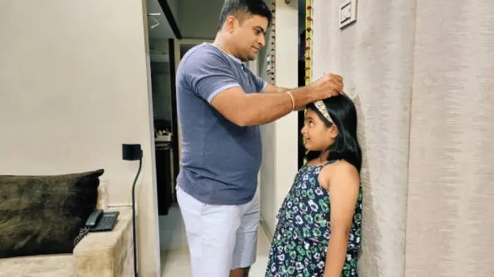 Indian Kids And Parents Measuring Height