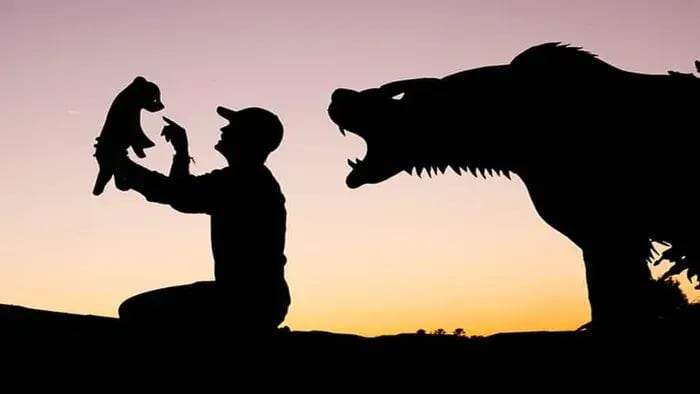 Black silhouette art of a man and an animal