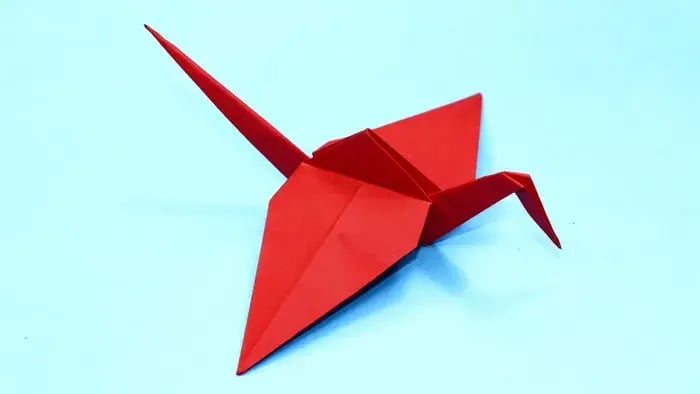 Red flamingo origami kept on a slab