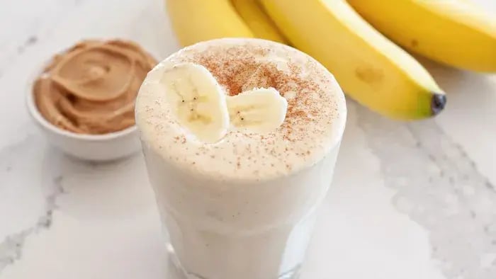 Banana smoothie with bananas in the background