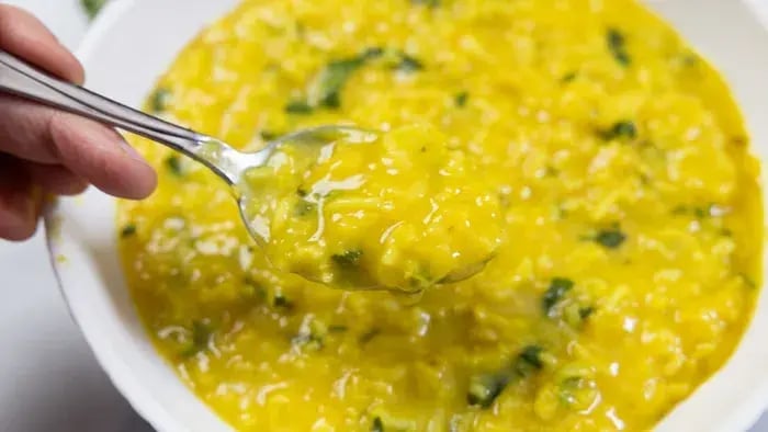 Yellow dal and rice khichdi with coriander garnish