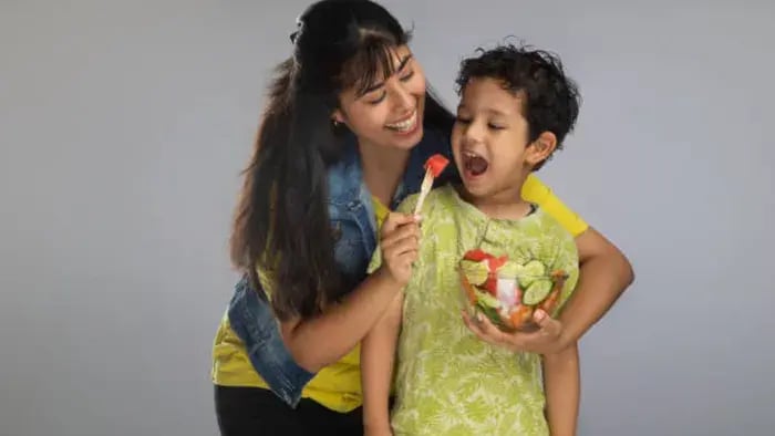 Indian kid and parents eating fruits