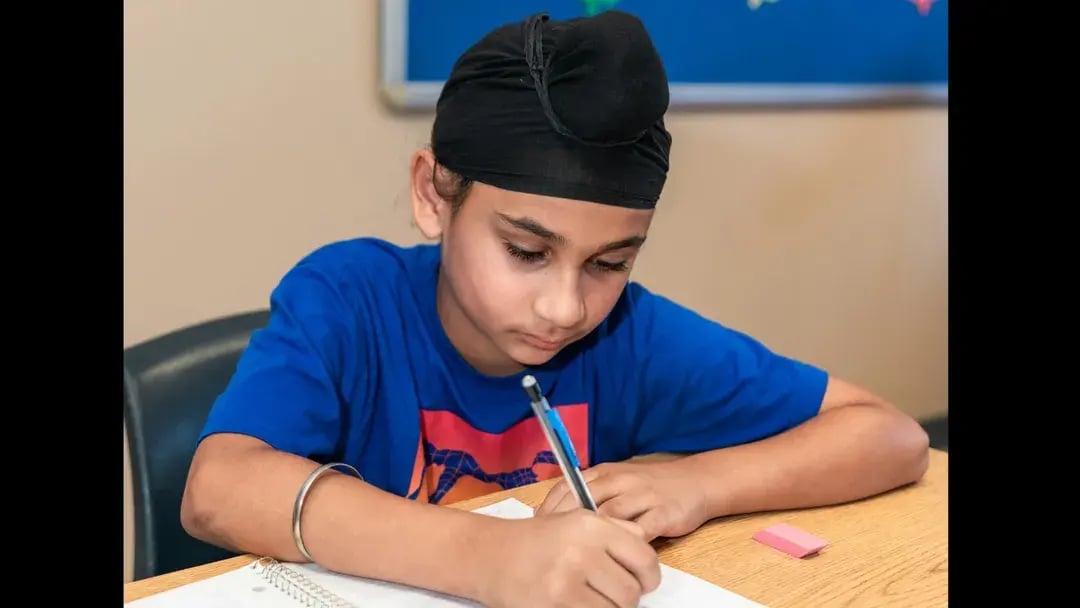 kid studying on a desk