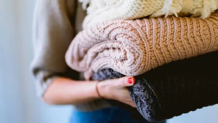 mother holding folded clothes