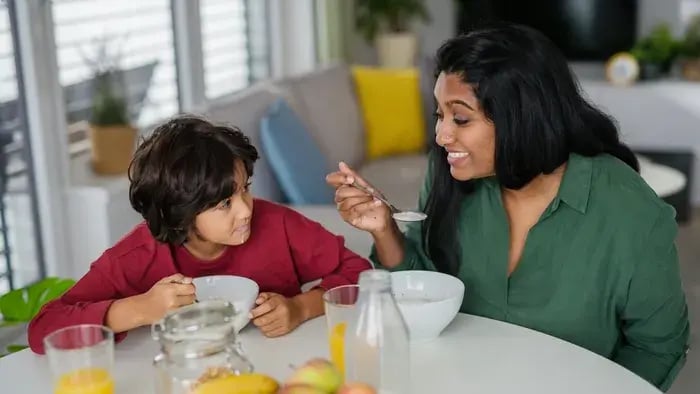 mother having breakfast with child