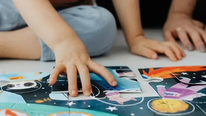 Fun and Educational Activities for Kids to Learn and Play at Home - Child playing with jigsaw puzzle