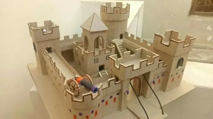 Brown colored mini castle made from cardboards