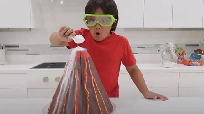 Indian Child Adding Baking Soda To Volcano Experiment