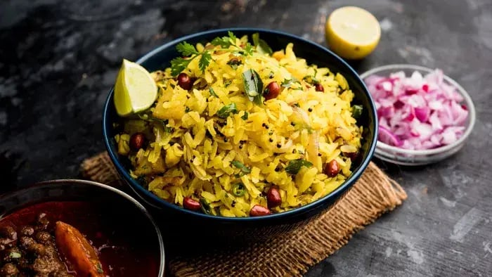 cooked poha with vegetables in a bowl