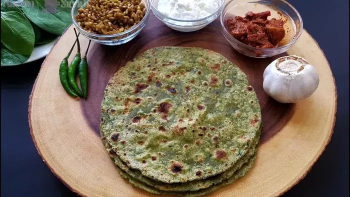 palak roti with curd on a plate