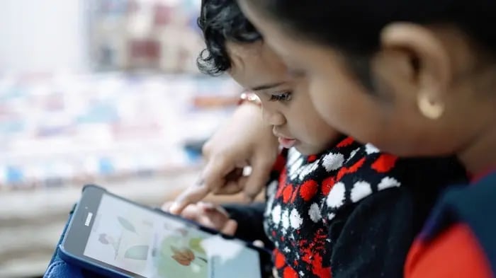 Child Reading From A Tablet