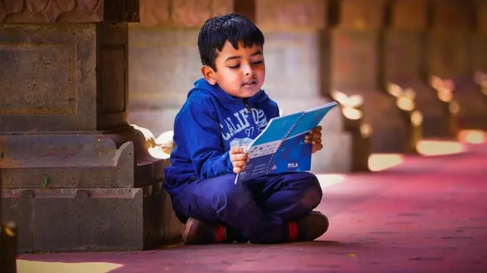 Kid Reading From A Book