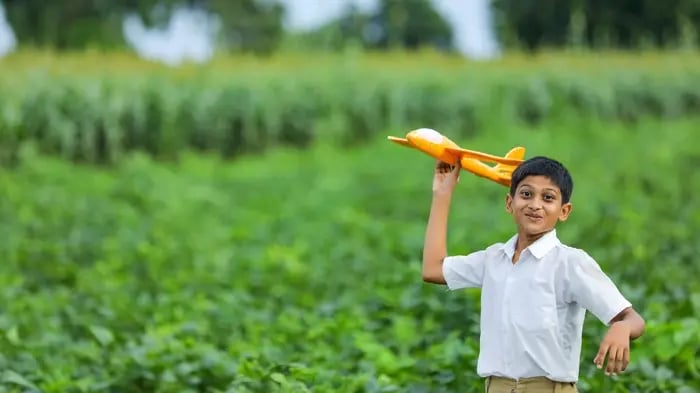 kid with a toy plane