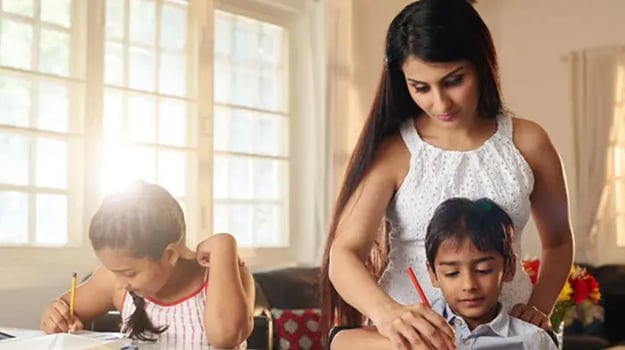 Mother helping her children study