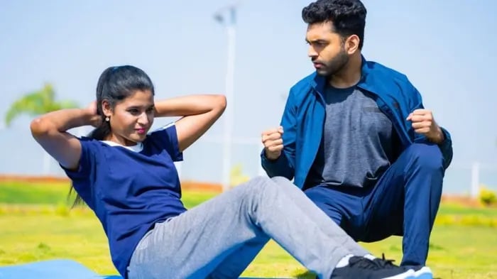 Woman And Man Exercising