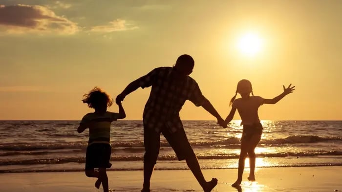 A Happy Family Having A Beach Dance-Off