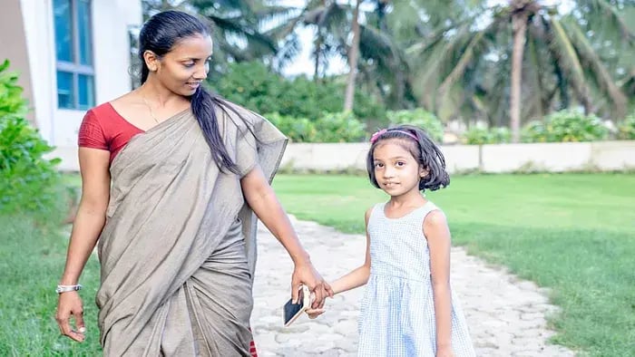 Mother holding daughter's hand