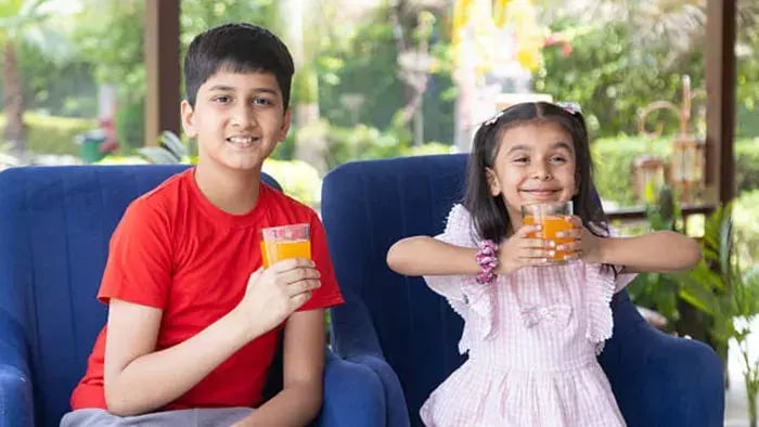 Indian kids drinking juice