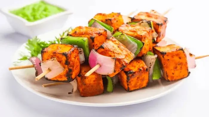 Nutritious Kid's Meals: Easy and Tasty Recipes for Busy Parents - Paneer tikka with grilled vegetables on a plate