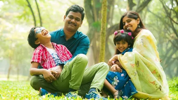 Family smiling while sitting
